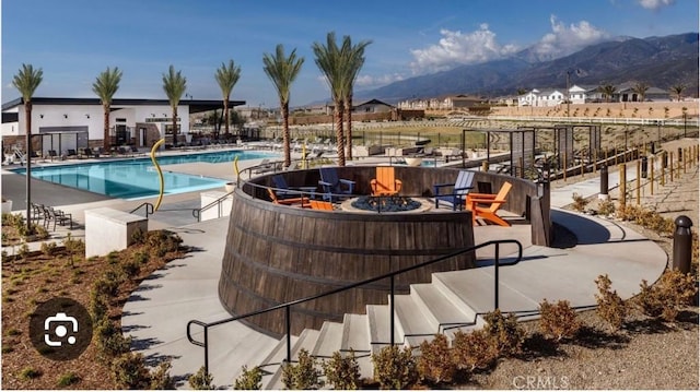 16654 Emerson Ln, Fontana, CA 92336 - community pool featuring a fire pit, a mountain view, and a patio area