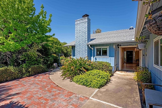 5221 Olive Hill Rd, Fallbrook, CA 92028 - doorway to property with board and batten siding, roof with shingles, and a chimney