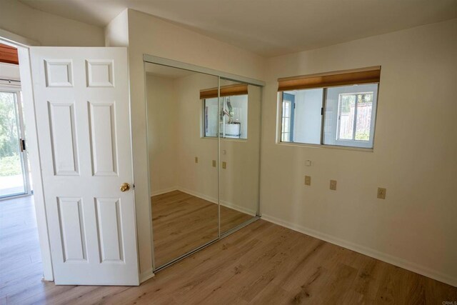 5221 Olive Hill Rd, Fallbrook, CA 92028 - unfurnished bedroom with wood finished floors, baseboards, and a closet