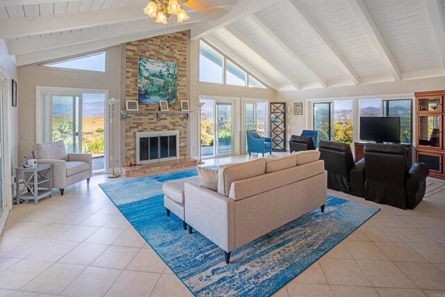 5221 Olive Hill Rd, Fallbrook, CA 92028 - living area featuring light tile patterned floors, beam ceiling, a fireplace, high vaulted ceiling, and a ceiling fan