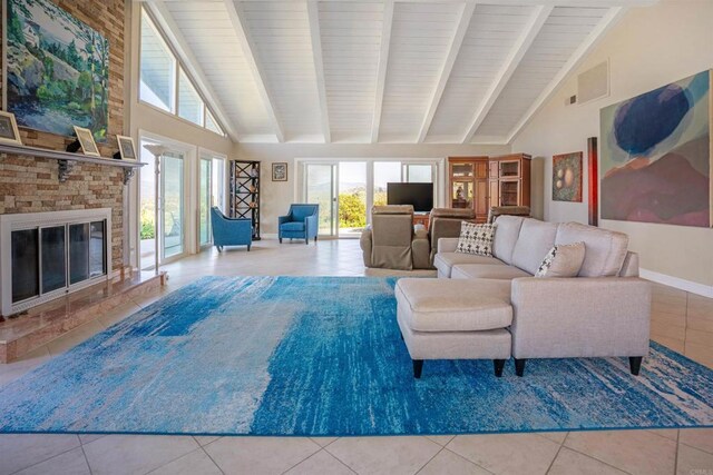 5221 Olive Hill Rd, Fallbrook, CA 92028 - tiled living room with high vaulted ceiling, beamed ceiling, a glass covered fireplace, and baseboards