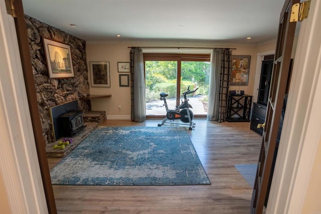 5221 Olive Hill Rd, Fallbrook, CA 92028 - workout area with crown molding, baseboards, a wood stove, wood finished floors, and recessed lighting