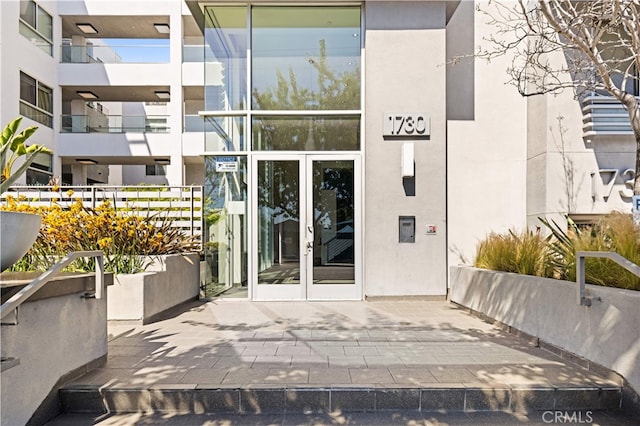 doorway to property with french doors and stucco siding