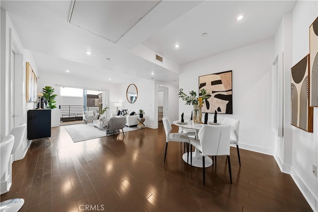 dining room with attic access, baseboards, dark wood-style floors, and recessed lighting