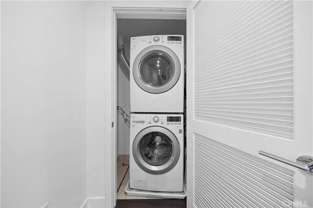 laundry room with stacked washer / dryer