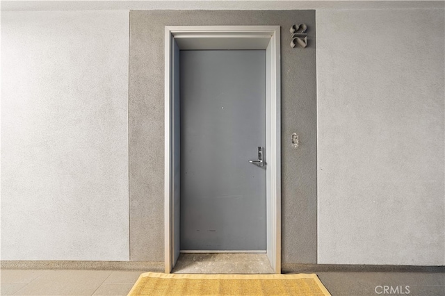 entrance to property with stucco siding