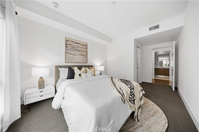 bedroom featuring dark colored carpet and baseboards