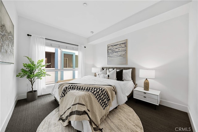 carpeted bedroom with baseboards
