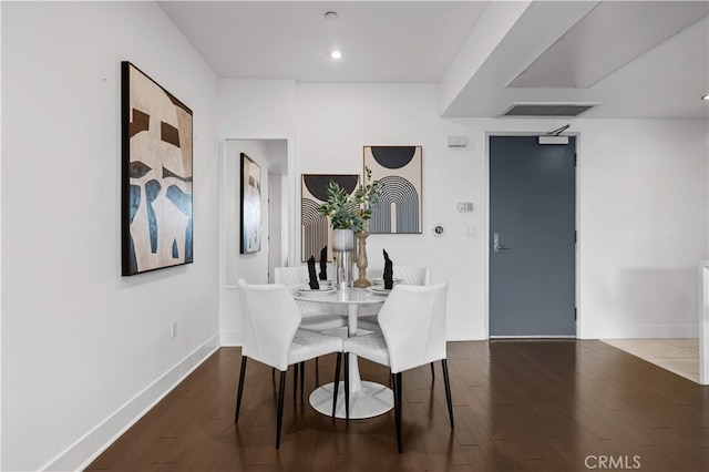 dining area featuring wood finished floors, baseboards, and recessed lighting