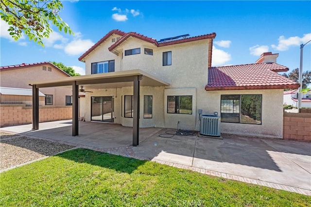 back of property with cooling unit, stucco siding, a tile roof, a ceiling fan, and a patio area