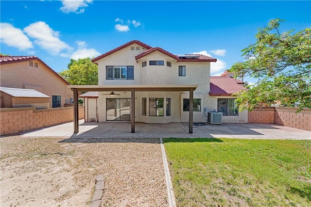 back of property featuring central AC, a ceiling fan, roof mounted solar panels, a tiled roof, and stucco siding