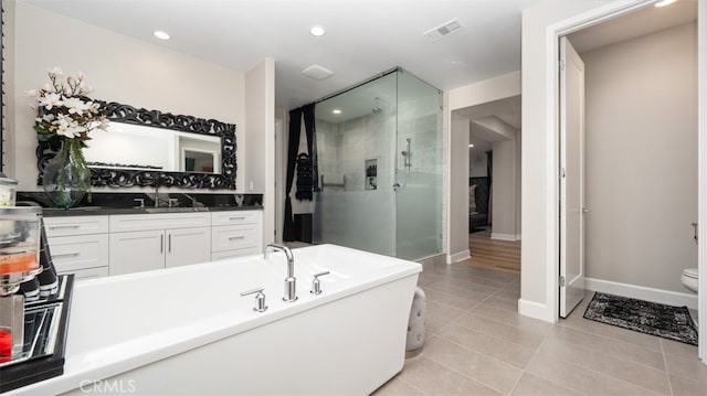 8798 Justify Dr, Rancho Cucamonga, CA 91701 - full bathroom with a stall shower, vanity, tile patterned flooring, a freestanding tub, and toilet
