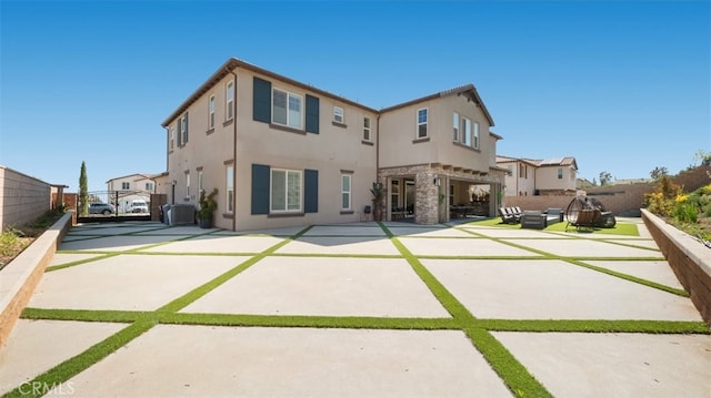 8798 Justify Dr, Rancho Cucamonga, CA 91701 - rear view of house with stucco siding, a gate, a patio, fence, and cooling unit