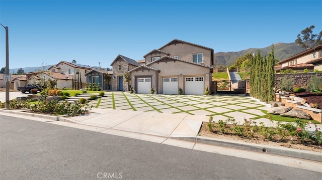 8798 Justify Dr, Rancho Cucamonga, CA 91701 - mediterranean / spanish house featuring a garage, driveway, a mountain view, stucco siding, and fence