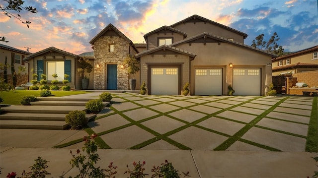 8798 Justify Dr, Rancho Cucamonga, CA 91701 - mediterranean / spanish-style house featuring concrete driveway, stone siding, and a garage