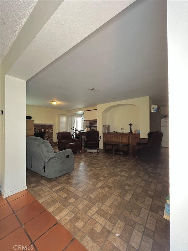 9846 Tamarind Ave, Bloomington, CA 92316 - living area with a brick fireplace and brick patterned flooring