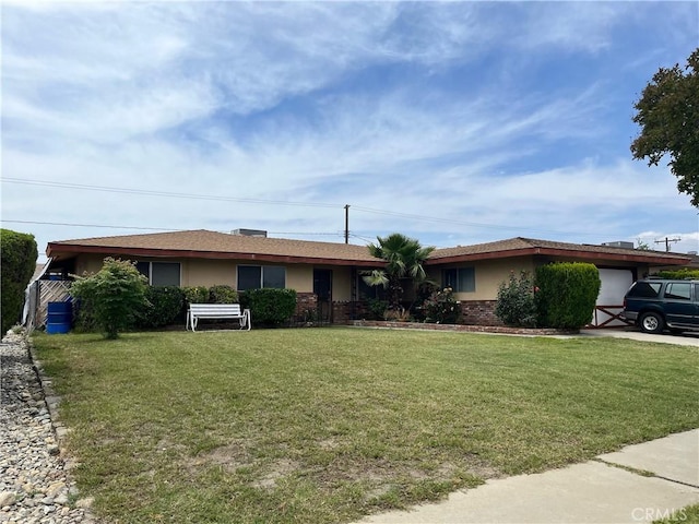 9846 Tamarind Ave, Bloomington, CA 92316 - single story home featuring a front lawn, an attached garage, stucco siding, and brick siding