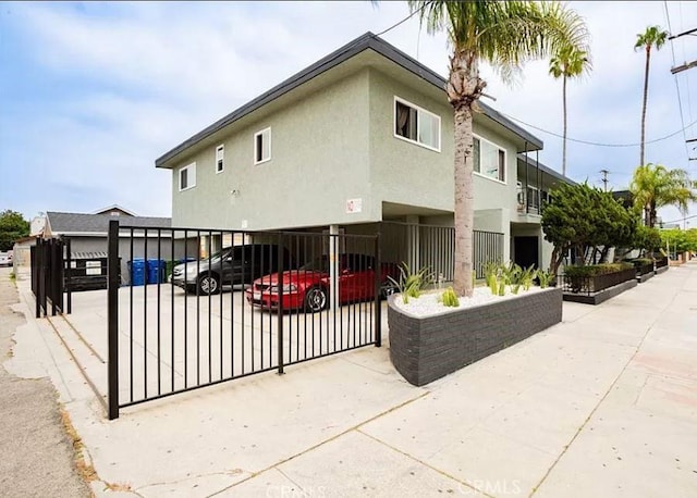 view of side of home with stucco siding and a carport