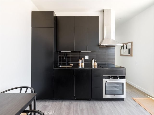1375 Fortuna Ave, Landers, CA 92285 - kitchen with oven, exhaust hood, a sink, light wood-style floors, and modern cabinets