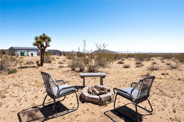1375 Fortuna Ave, Landers, CA 92285 - view of yard featuring a fire pit, view of desert, a mountain view, and a rural view