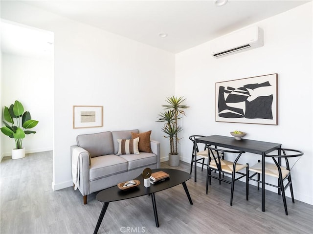 1375 Fortuna Ave, Landers, CA 92285 - sitting room with an AC wall unit, wood finished floors, baseboards, and recessed lighting