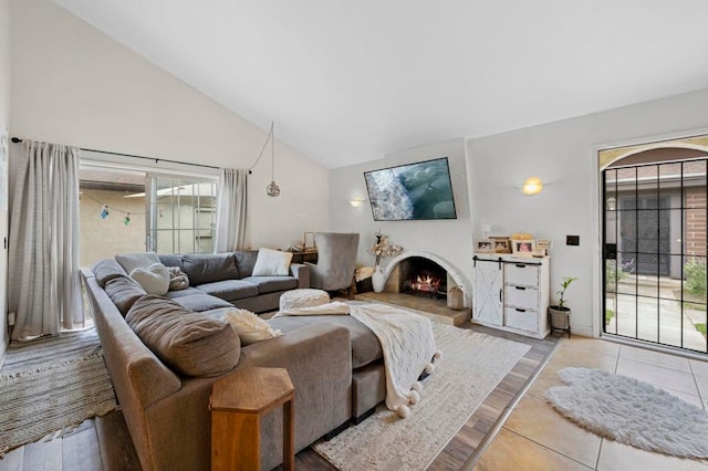 3470 Peach Tree Way, Oceanside, CA 92058 - living room featuring a lit fireplace, high vaulted ceiling, healthy amount of natural light, and tile patterned flooring