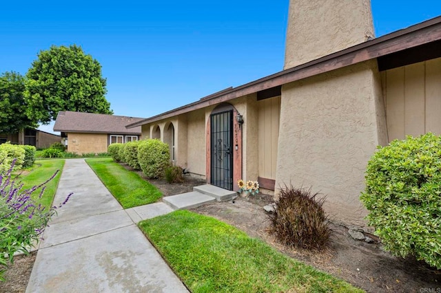 3470 Peach Tree Way, Oceanside, CA 92058 - property entrance with stucco siding and a yard
