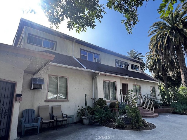 239255 N Sierra Bonita Ave, Pasadena, CA 91106 - view of front of house with stucco siding and a patio area