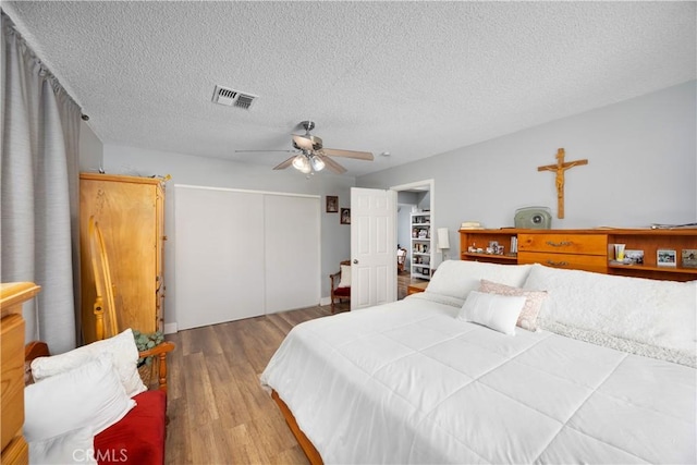 1118 Kwis Ave, Hacienda Heights, CA 91745 - bedroom featuring wood finished floors, a closet, a textured ceiling, and ceiling fan