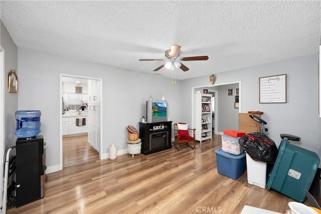 1118 Kwis Ave, Hacienda Heights, CA 91745 - recreation room featuring ceiling fan, light wood-style floors, and a textured ceiling