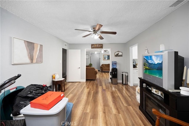 1118 Kwis Ave, Hacienda Heights, CA 91745 - living area with a ceiling fan, wood finished floors, and a textured ceiling