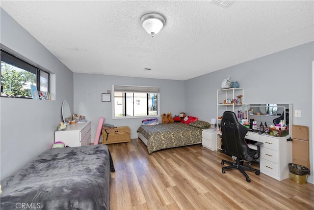 1118 Kwis Ave, Hacienda Heights, CA 91745 - bedroom with a textured ceiling, light wood-style floors, and an office area