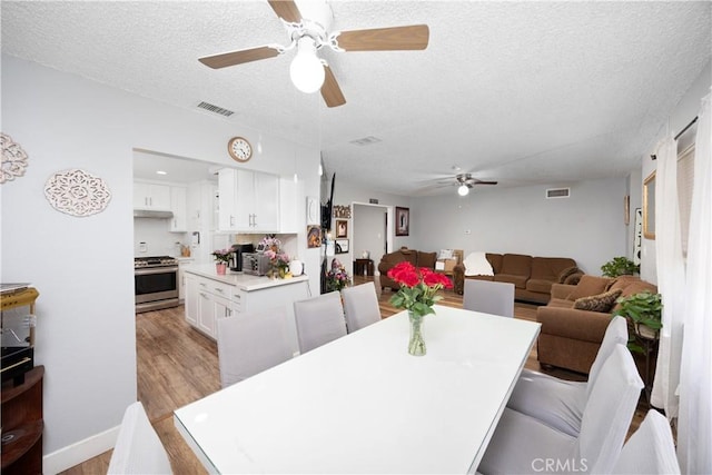 1118 Kwis Ave, Hacienda Heights, CA 91745 - dining room featuring ceiling fan, a textured ceiling, and light wood finished floors