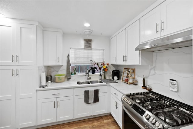 1118 Kwis Ave, Hacienda Heights, CA 91745 - kitchen featuring a sink, gas range, under cabinet range hood, white cabinetry, and light stone countertops