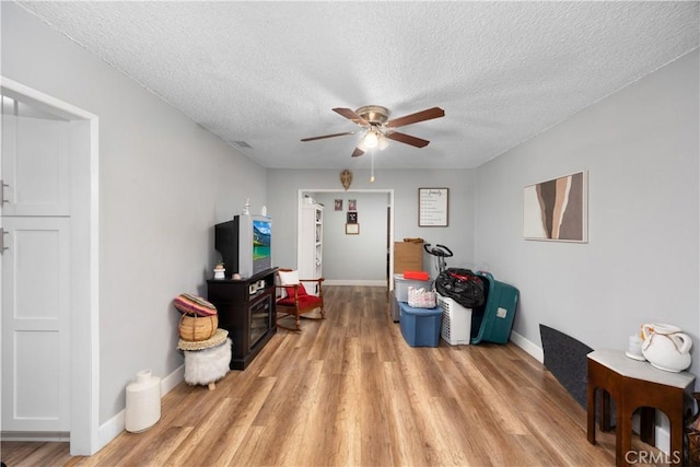 1118 Kwis Ave, Hacienda Heights, CA 91745 - living room with ceiling fan, a textured ceiling, light wood finished floors, and baseboards