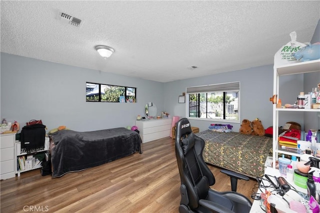 1118 Kwis Ave, Hacienda Heights, CA 91745 - bedroom with a textured ceiling, wood finished floors, and a desk