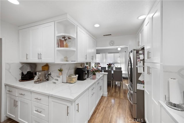 1118 Kwis Ave, Hacienda Heights, CA 91745 - kitchen featuring open shelves, white cabinetry, light wood-style flooring, freestanding refrigerator, and backsplash