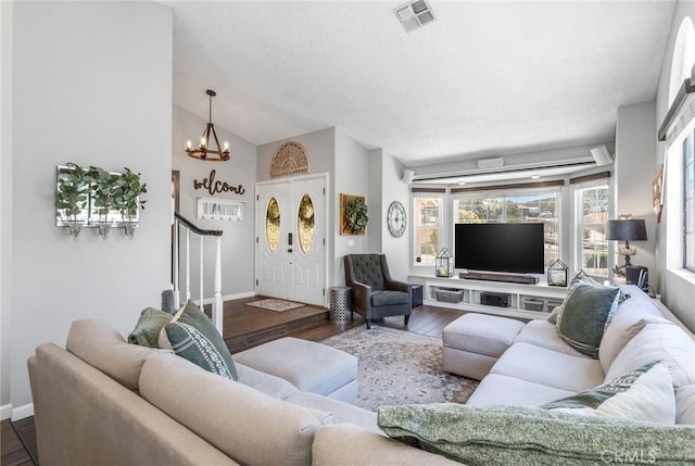 33693 Cattle Creek Rd, Acton, CA 93510 - living room with a chandelier, stairs, wood finished floors, baseboards, and vaulted ceiling
