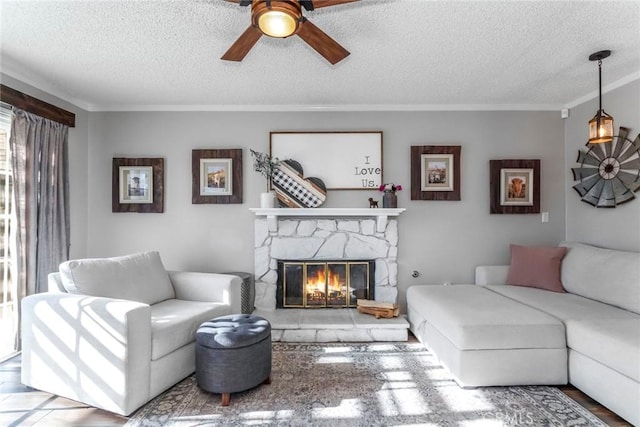 33693 Cattle Creek Rd, Acton, CA 93510 - living area featuring a ceiling fan, ornamental molding, a fireplace, and a textured ceiling