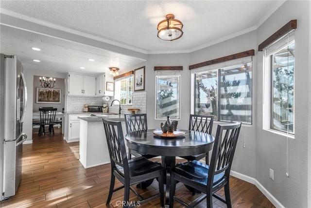 33693 Cattle Creek Rd, Acton, CA 93510 - dining room featuring a chandelier, dark wood-style floors, ornamental molding, recessed lighting, and baseboards