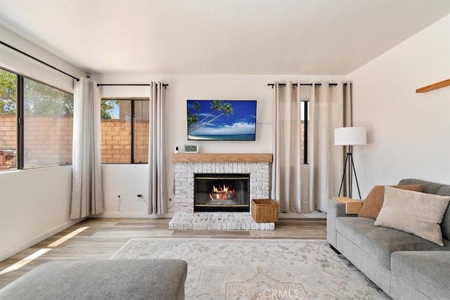 6517 Via Del Prado, Chino Hills, CA 91709 - living room featuring plenty of natural light, wood finished floors, a brick fireplace, and baseboards