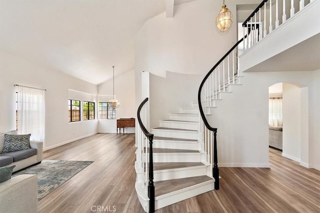6517 Via Del Prado, Chino Hills, CA 91709 - staircase with a chandelier, high vaulted ceiling, arched walkways, and wood finished floors