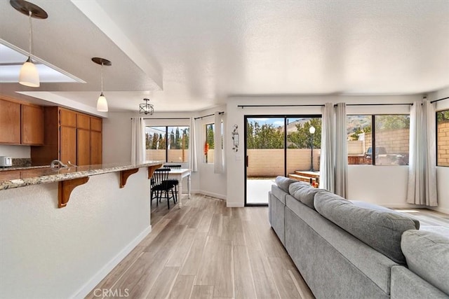 6517 Via Del Prado, Chino Hills, CA 91709 - living room with baseboards, plenty of natural light, and light wood-style flooring