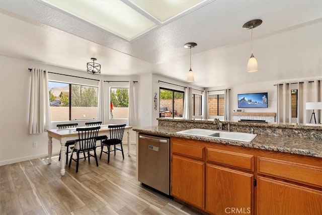 6517 Via Del Prado, Chino Hills, CA 91709 - kitchen with stainless steel dishwasher, a sink, brown cabinetry, light wood-type flooring, and pendant lighting