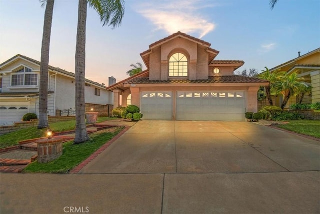 6517 Via Del Prado, Chino Hills, CA 91709 - mediterranean / spanish house featuring stucco siding, a garage, a tile roof, and driveway