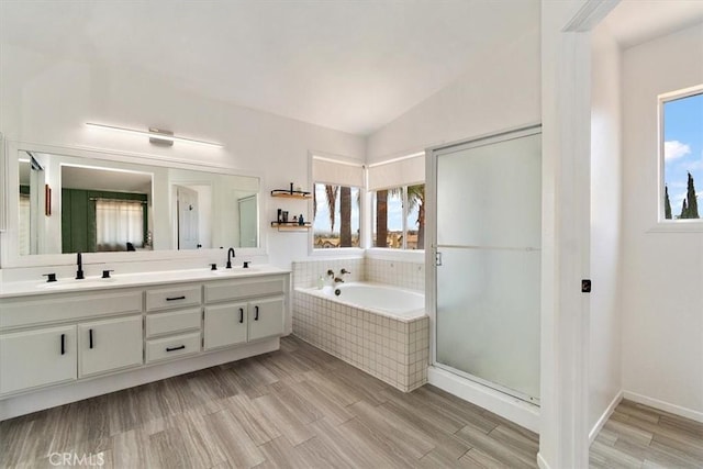 6517 Via Del Prado, Chino Hills, CA 91709 - bathroom featuring double vanity, a garden tub, a shower stall, lofted ceiling, and wood finished floors