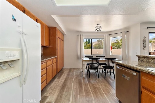 6517 Via Del Prado, Chino Hills, CA 91709 - kitchen with white refrigerator with ice dispenser, dishwasher, brown cabinetry, light wood-style floors, and healthy amount of natural light