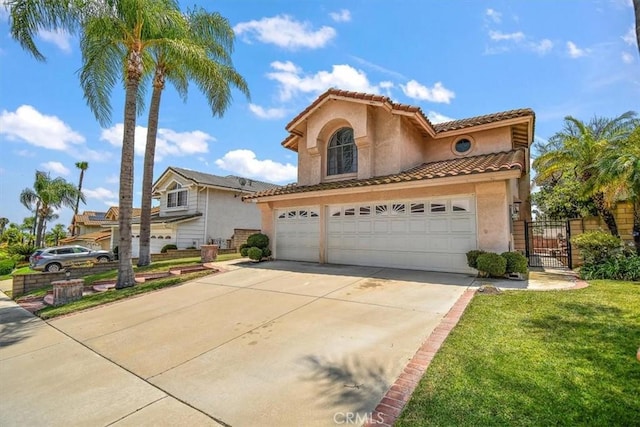 6517 Via Del Prado, Chino Hills, CA 91709 - mediterranean / spanish home featuring stucco siding, driveway, a tile roof, a garage, and a gate
