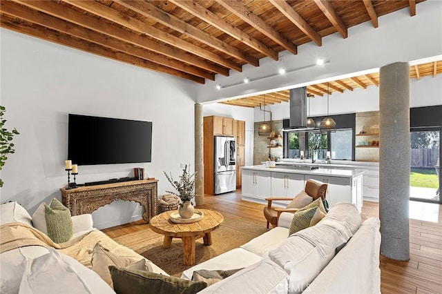 31303 Andres Pico Rd, San Juan Capistrano, CA 92675 - living room featuring beamed ceiling, wooden ceiling, healthy amount of natural light, and light wood-type flooring