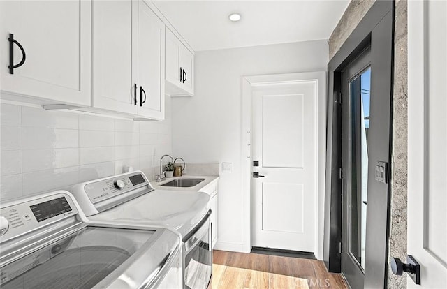 31303 Andres Pico Rd, San Juan Capistrano, CA 92675 - washroom featuring washer and clothes dryer, cabinet space, and light wood-style floors